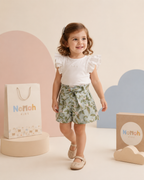Conjunto Pérolla – Menina caminhando com conjunto e sacolas Nonoh Kids